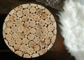 Rustic small table made of wooden circles of different sizes on a wooden floor