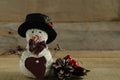 Primitive snowman and pine cone on wood background Royalty Free Stock Photo