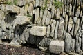 Rustic solid stone steps going up a rough built stone wall with lichen and grass growing. Royalty Free Stock Photo
