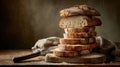 Rustic sourdough bread stacked high on a wooden surface with burlap Royalty Free Stock Photo