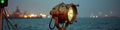 Rustic spotlight by seaside harbor at dusk with bokeh lights in background Royalty Free Stock Photo