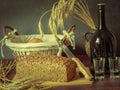 Rustic still life in antique style with bread, ears of wheat . Royalty Free Stock Photo