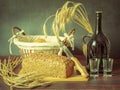 Rustic still life in antique style with bread, ears of wheat . Royalty Free Stock Photo