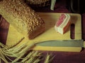 Rustic still life in antique style with bread, ears of wheat . Royalty Free Stock Photo