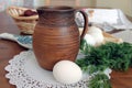 Rustic still life with clay jug and eggs Royalty Free Stock Photo