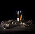 Rustic still life. cup of tea and quail eggs on a wooden table. black background