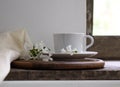 Rustic still life. cup of tea on the window sill and white phlox flowers. vintage wooden background. close-up