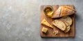 A rustic still life featuring bread, cheese, and oil on a wooden board. Generative AI Royalty Free Stock Photo