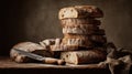 Artisan sourdough bread stacked and sliced with knife on rustic table Royalty Free Stock Photo