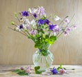 Rustic still life in a glass vase beautiful flowers pink white blue Aquilegia wooden background. AquilÃÂ©gia vulgÃÂ¡ris of the Royalty Free Stock Photo