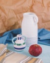 Rustic still life with white and coloured jug and pomegranate Royalty Free Stock Photo