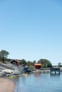 Rustic Stockholm archipelago scene with red paint cottages on rocky seashore Royalty Free Stock Photo