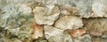 Rustic stone cladding, with a diverse array of shapes and a palette of earthy tones creating a natural textured surface. Royalty Free Stock Photo