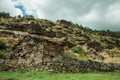 Rustic stone house on a hilly landscape