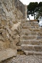 Rustic stone staircase next to a stone wall Royalty Free Stock Photo