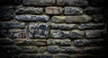 A rustic stone wall composed of dark, irregularly shaped stones with weathered Royalty Free Stock Photo