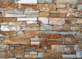 Rustic stone wall made of irregular bricks with different size, geometrically arranged. in horizontal rows Royalty Free Stock Photo