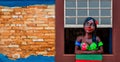 Rustic stone wall and window with a flirting doll in Brazil Royalty Free Stock Photo