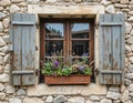 Rustic Stone Wall Window with Open Shutters and Flower Box Royalty Free Stock Photo