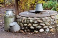 Rustic stone well, can and bucket