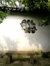 Rustic stone window in ancient Chinese garden Royalty Free Stock Photo