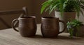 Rustic Stoneware Mugs with Stamped Initials in a Cozy Still Life Setting Royalty Free Stock Photo