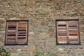Rustic style brown wood window closed on stone house Royalty Free Stock Photo
