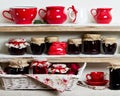 A rustic style. Ceramic tableware and kitchenware in red on the Royalty Free Stock Photo