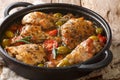 Rustic style chicken baked with green olives, tomatoes and onions, herbs close-up in a pan. horizontal Royalty Free Stock Photo