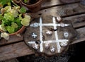 Rustic style crosses-zeros game made from wooden log and stones