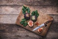 Rustic style Cut figs with knife on chopping board and wooden ta