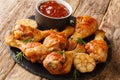 Rustic style Delicious grilled chicken drumsticks with garlic and rosemary with bbq sauce close-up on a slate board. horizontal Royalty Free Stock Photo