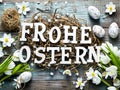 Rustic style Easter decoration with eggs and flowers. German text letters