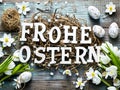 Rustic style Easter decoration with eggs and flowers. German text letters Royalty Free Stock Photo