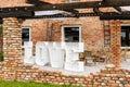 A rustic-style garden terrace lined with small pebbles - there are bamboo chairs and vegetation on the terrace Royalty Free Stock Photo