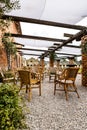 A rustic-style garden terrace lined with small pebbles - there are bamboo chairs Royalty Free Stock Photo