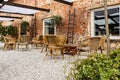 A rustic-style garden terrace lined with small pebbles - there are bamboo chairs and vegetation Royalty Free Stock Photo