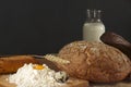 Rustic style still life with bread, egg, milk and a hill of wheat flour Royalty Free Stock Photo