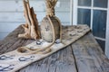 rustic table with anchorimprinted table runner, ropewrapped vase, and driftwood accents Royalty Free Stock Photo