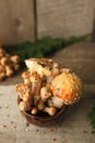 Woods, fairy tales & mysterious creature concept - poisonus mushrooms in the cup with confectionary decor on wooden table, magic Royalty Free Stock Photo