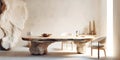 Rustic table made from solid natural aged wood slab on stones rubbles. Interior design of modern dining room with wild stone wall
