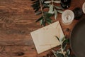 Rustic table place setting with linen napkin, olive branch on wooden background Royalty Free Stock Photo