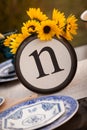 Rustic table setting with lettered plate. Royalty Free Stock Photo