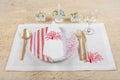 Rustic table setting on wooden table: gold vintage silverware, linen napkin and olive brunch. Romantic or wedding concept Royalty Free Stock Photo