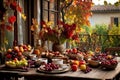 a rustic terrace filled with pots with autumn flowers and a vine full of red leaves and bunches of grapes. Royalty Free Stock Photo