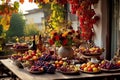 a rustic terrace filled with pots with autumn flowers and a vine full of red leaves and bunches of grapes. Royalty Free Stock Photo