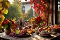 a rustic terrace filled with pots with autumn flowers and a vine full of red leaves and bunches of grapes.