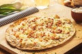 Rustic Thin Crust French Pizza on Wooden Cutting Board