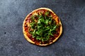 Rustic thin crust pizza with mozzarella, cherry tomatoes and cappers, topped with fresh arugula. Homemade