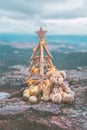 Christmas tree with golden star lights against mountain backdrop